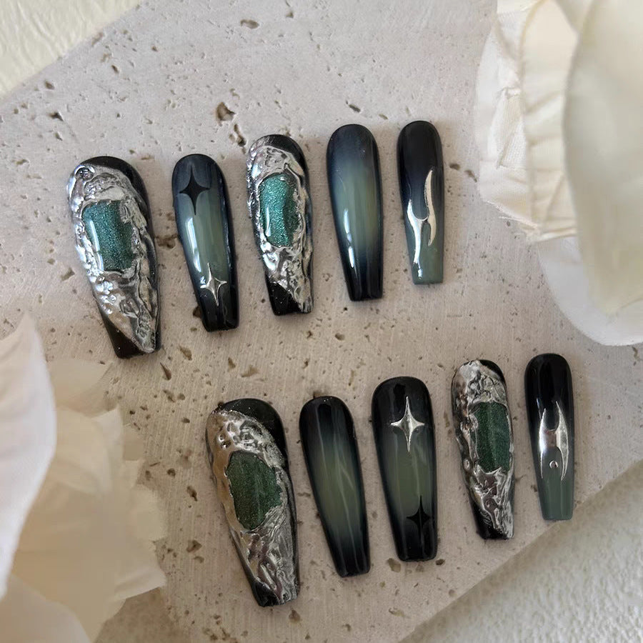 Handcrafted emerald nails with bold 3D metallic details.