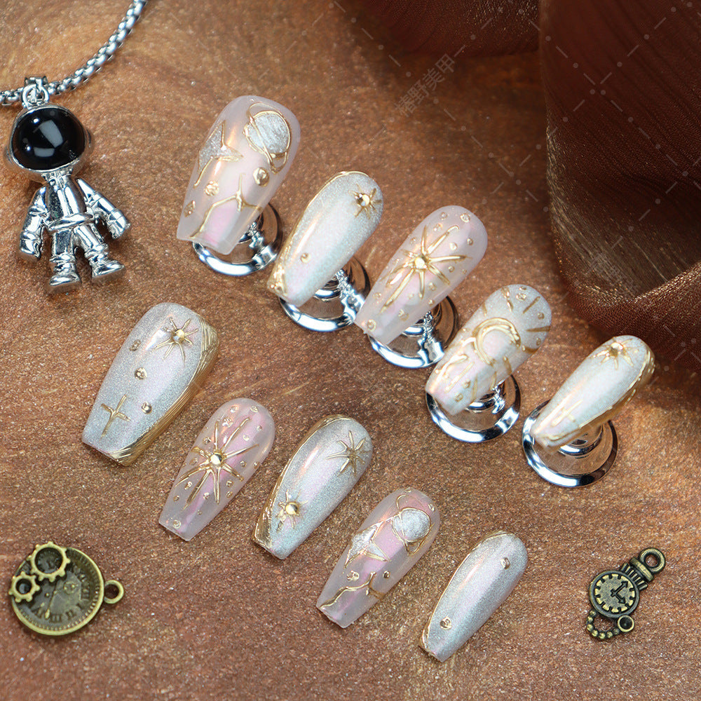 Handcrafted almond nails featuring moon and star motifs.