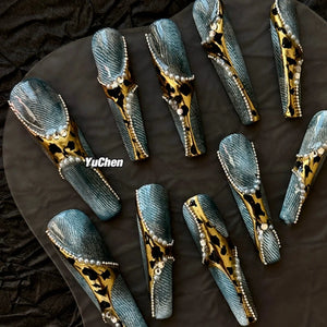 Denim coffin nails with leopard prints and pearl accents.