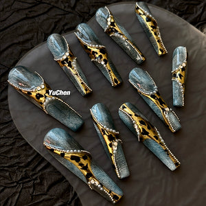 Bold leopard coffin nails with denim themes and luxurious bead accents.