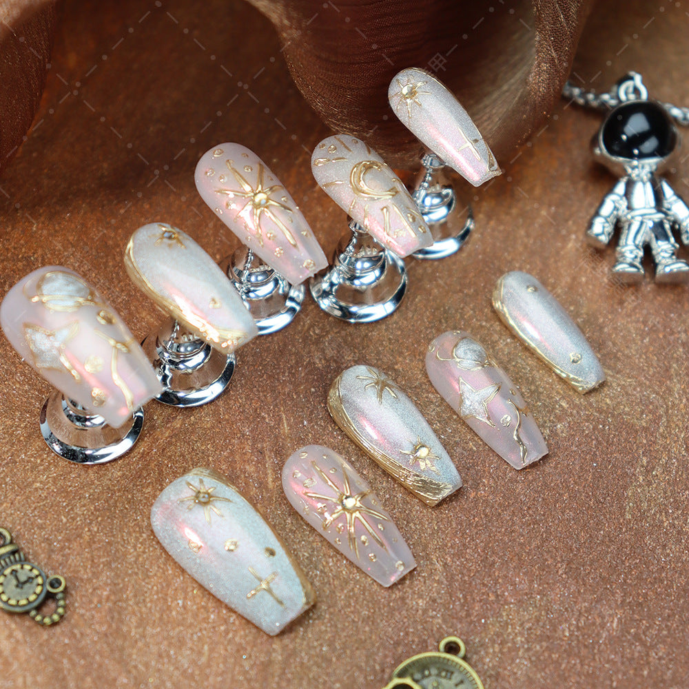 Bohemian almond nails with celestial-inspired gold star designs.