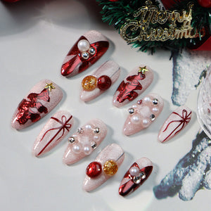 Medium-length almond nails with pearl detailing and festive designs.