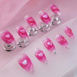 Individual pink press-on nail featuring a delicate heart accent.