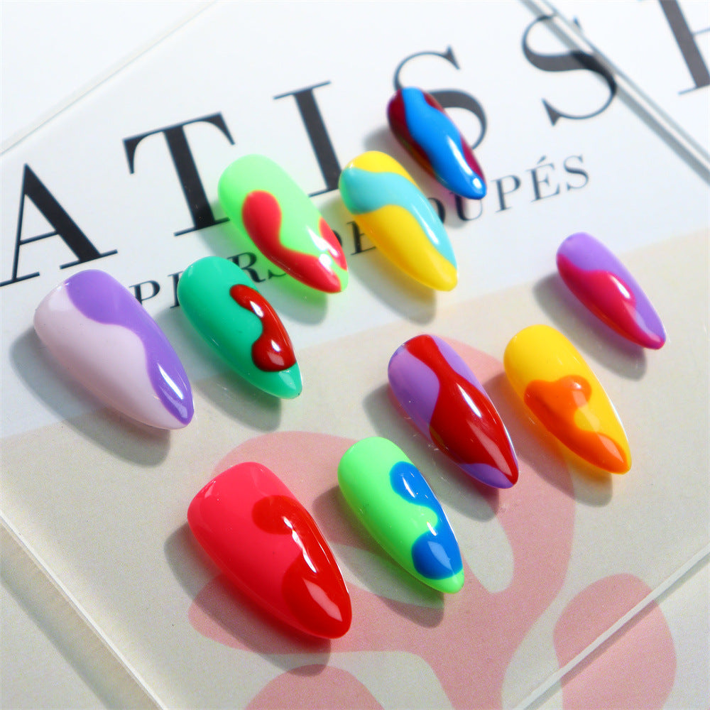 Close-up of almond press-on nails with multicolor details.