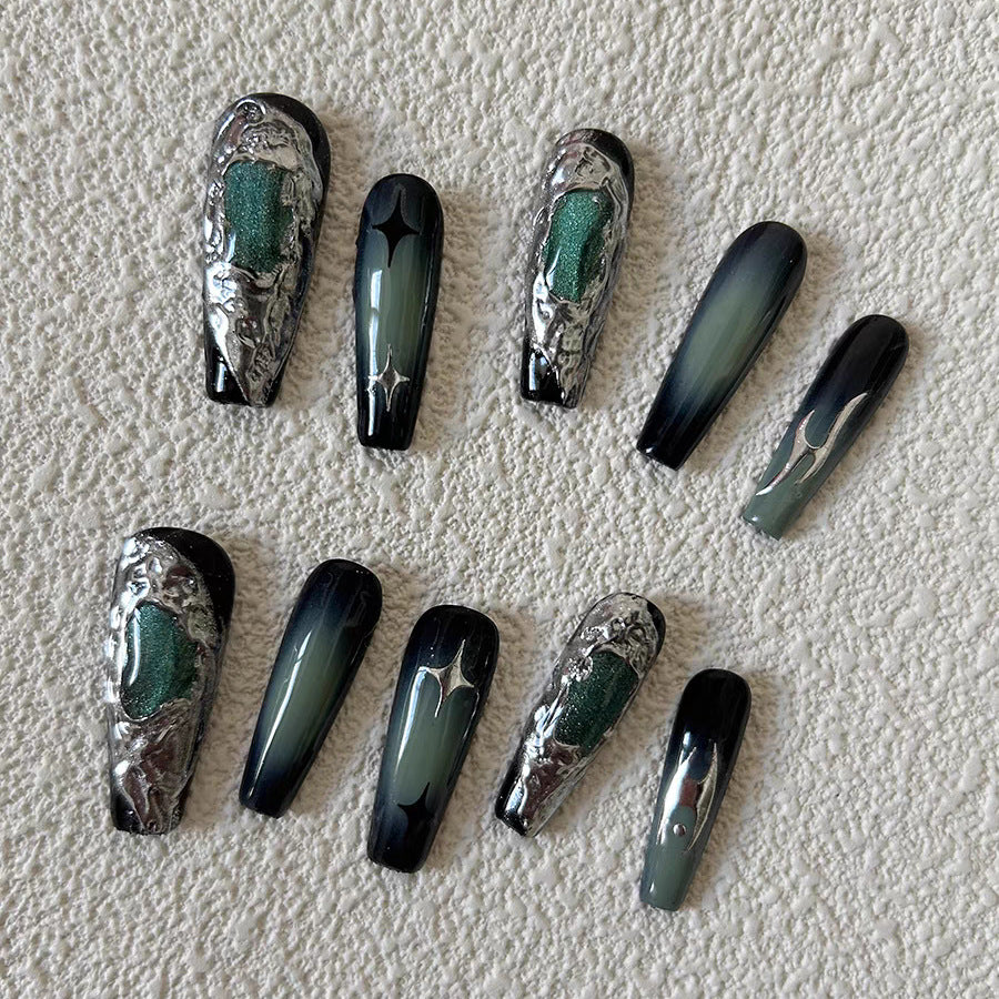 Long coffin nails featuring emerald green tones and shimmering metallic designs.