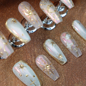 Medium-length almond nails with Bohemian star and moon patterns.