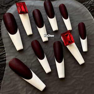 Dramatic long coffin nails with luxury red gemstones.