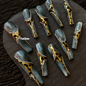 Luxurious coffin nails with denim designs, leopard patterns, and pearls.