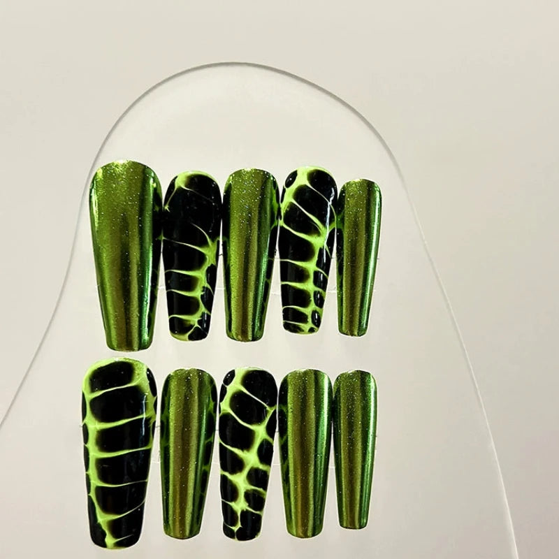 Long coffin nails featuring metallic green snake-skin designs.